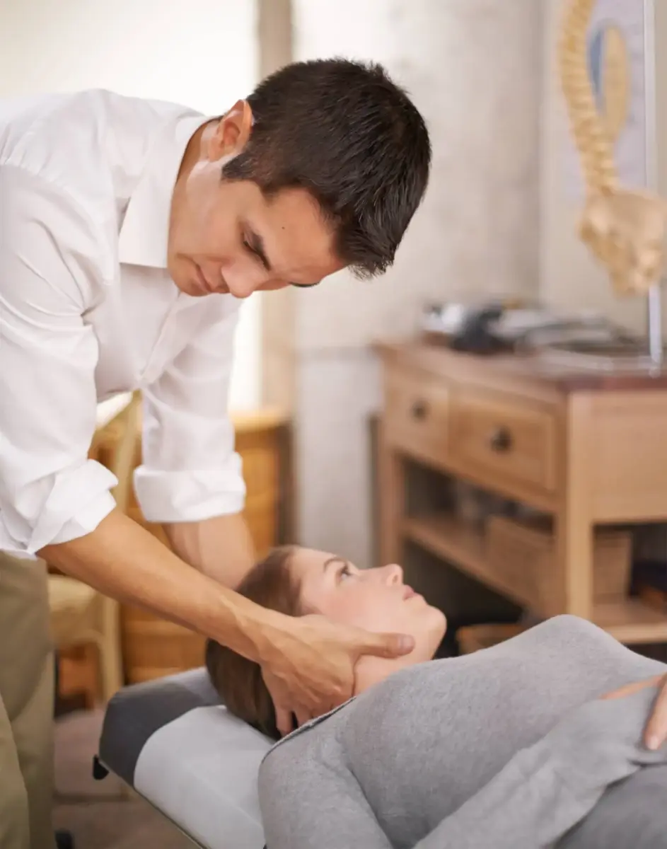 Chiropractor performing a cervical adjustment on a patient